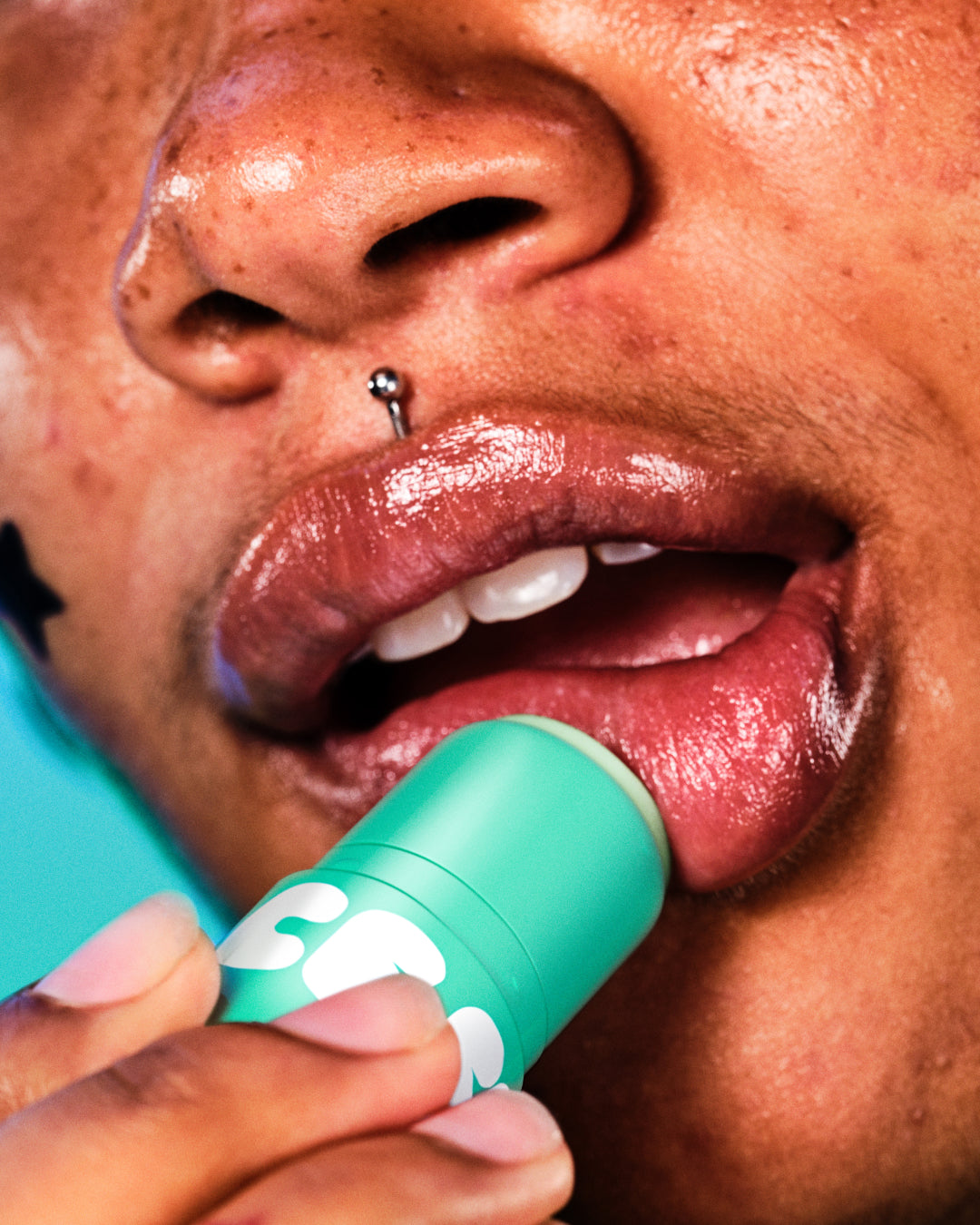 A model applies moisturizing Starface Star Balm Magic Mint lip balm on their lips. Tastes fresh, sweet, and creamy.