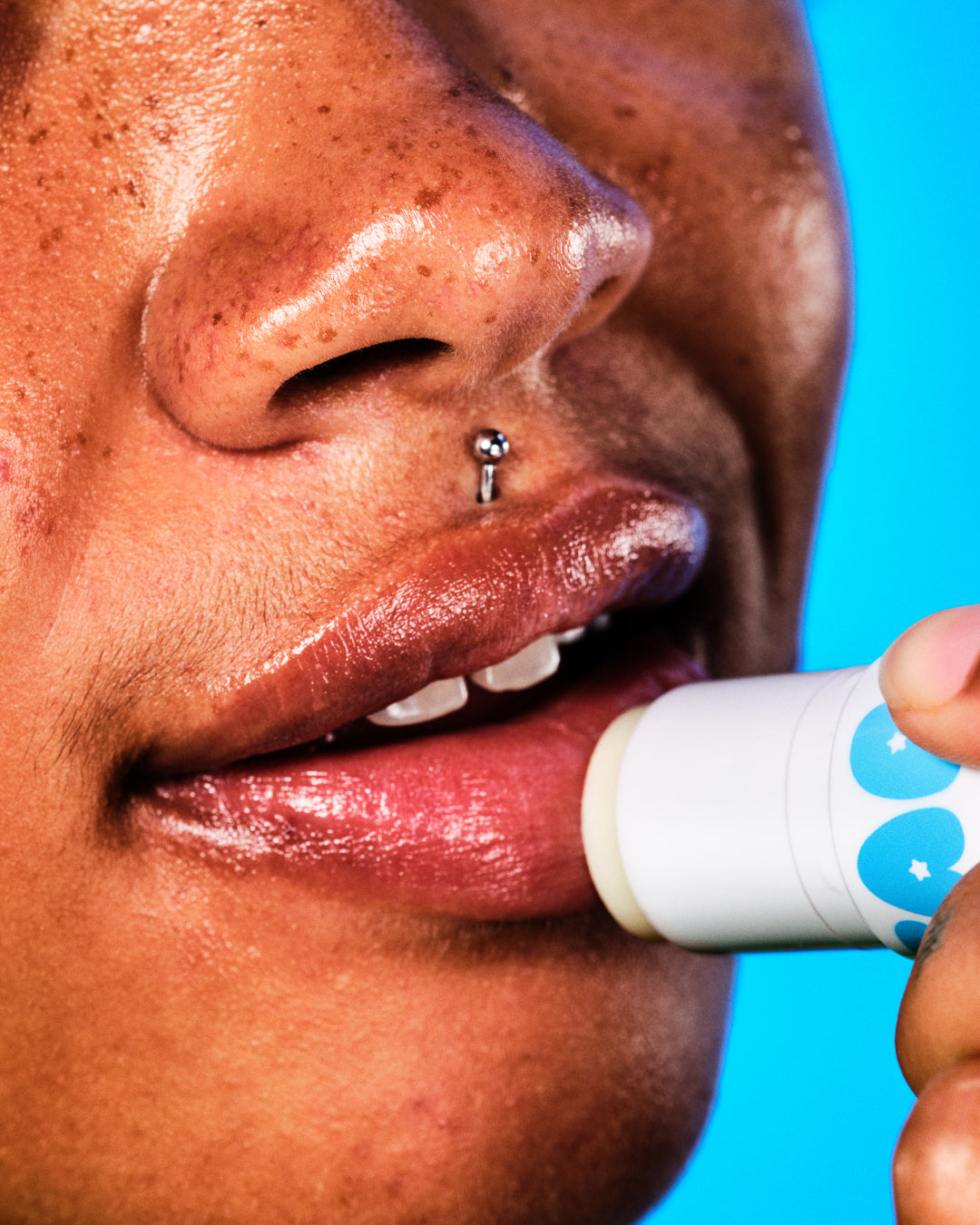 A model applies moisturizing Starface Star Balm Very Vanilla on their lips. Tastes sweet, soft, and dreamy.