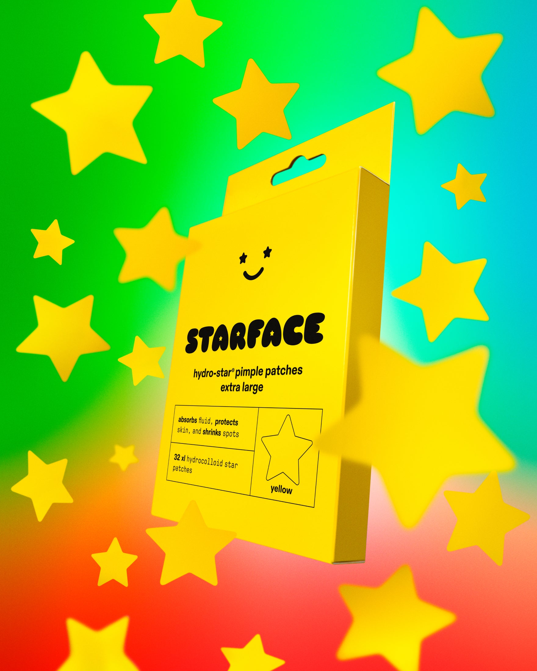 A yellow package of Starface XL Big Star pimple patches on a blue, green, and orange background with floating big yellow stars.
