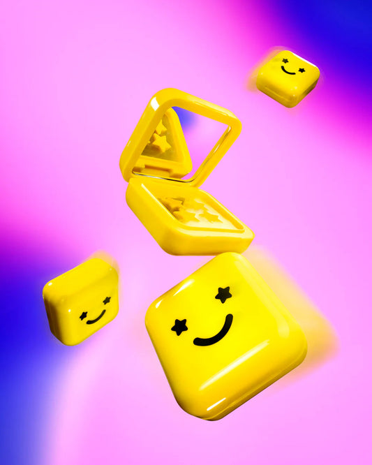 Four Big Yellow compacts with mirrors and yellow Hydro-Star® pimple patches inside float on a pink and purple background.