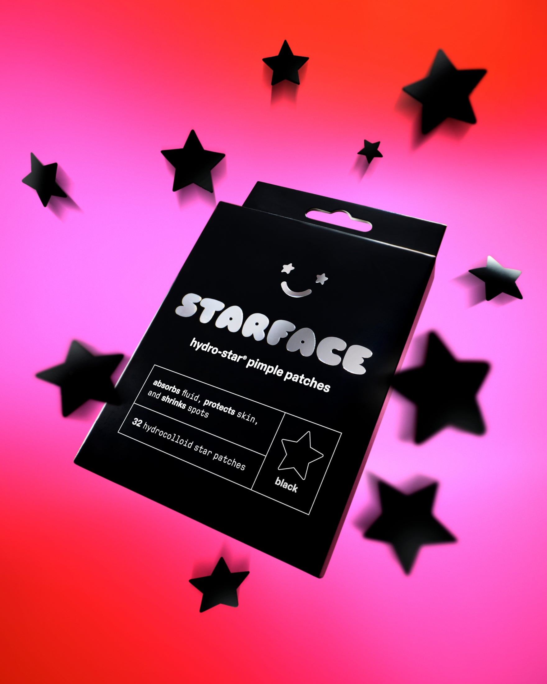 A package of black Hydro-Star® pimple patches on a pink background with floating black stars.