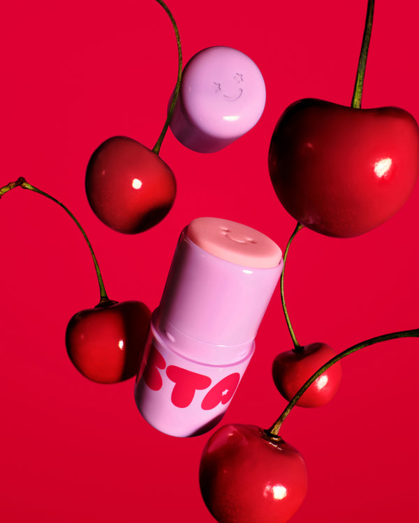 Starface Star Balm® Cherry Charm lip balm uncapped. Shea butter, cocoa butter and coconut oil soothe dry lips.