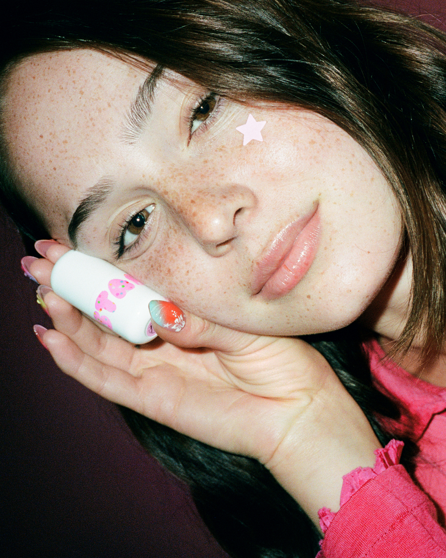 A person holds up Starface Star Balm® in Bday Cake. A sweet, frosted birthday cake lip balm for hydrated lips.